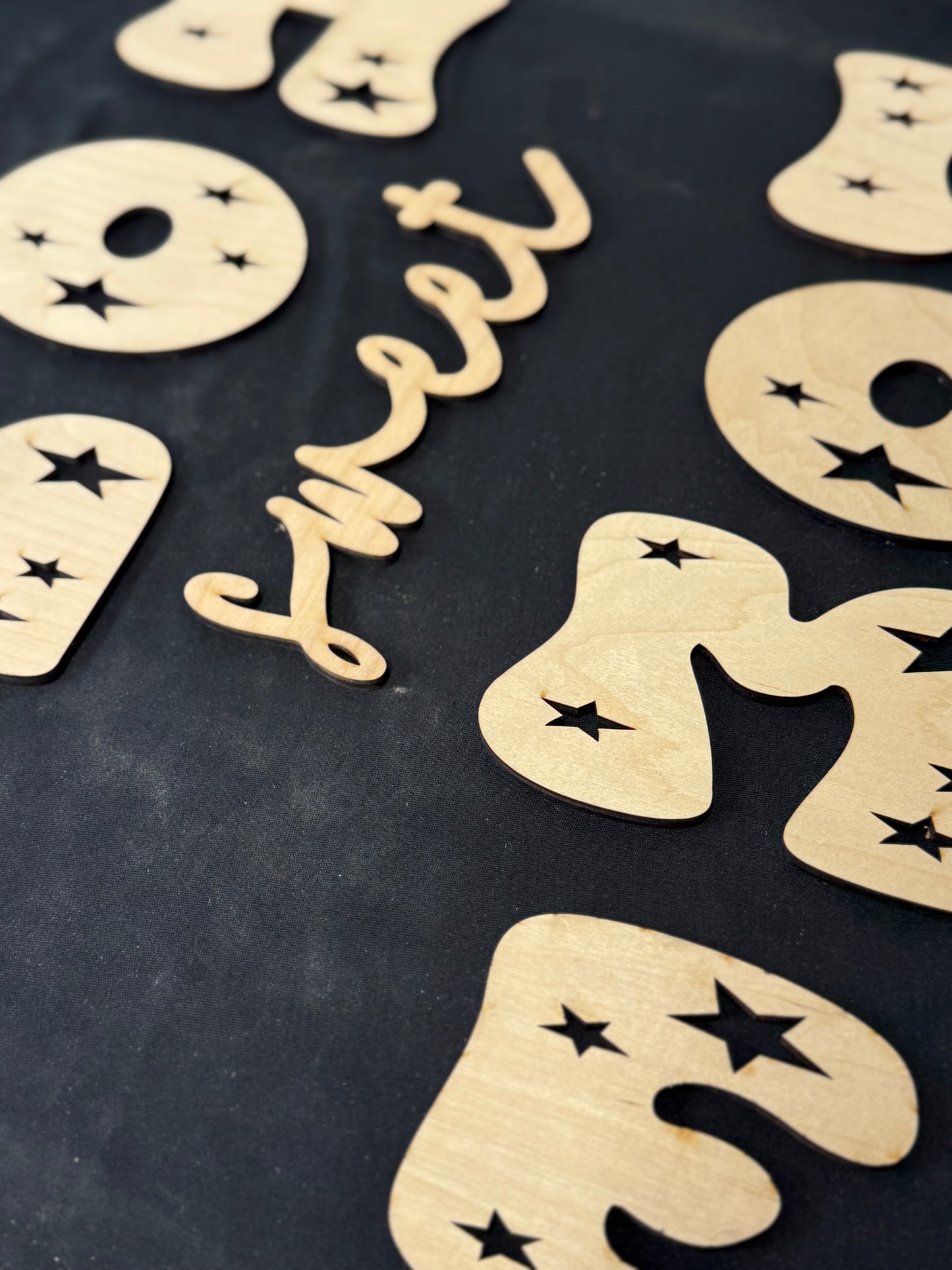 Wooden letters spelling 'sweet' on a black background for porch leaner kit 